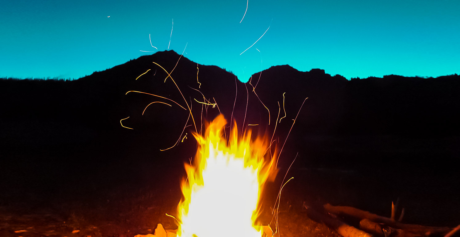 The smell of the campfire mingling with the freshness of the mountains in summer